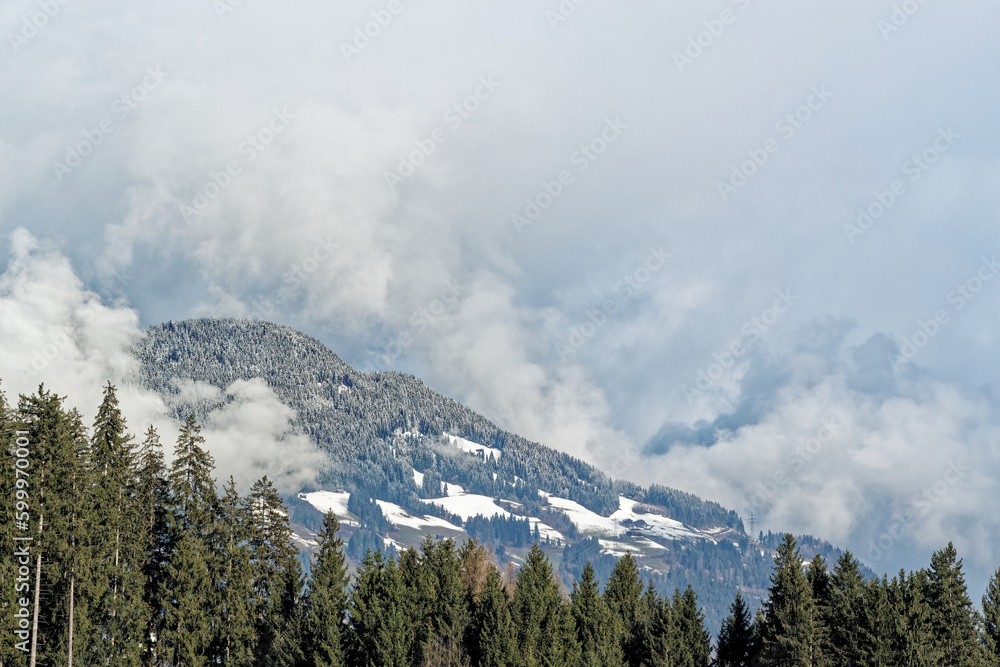 Forested mountains in dense clouds in a winter. Ziller Valle in, Austria Forested mountains in dense clouds in a winter. Ziller Valle in, Austria
