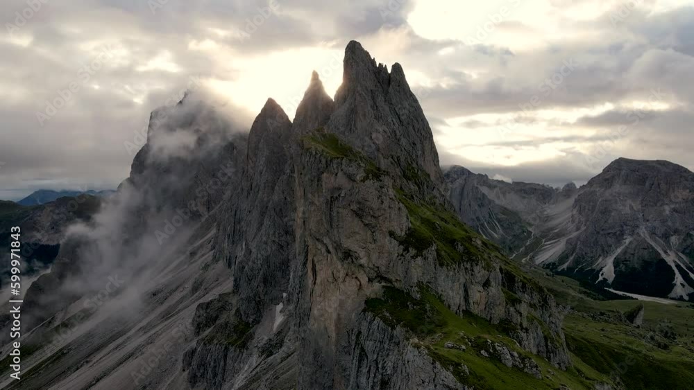Breathtaking aerial view of the Seceda mountain peaks during a foggy sunrise in the Dolomites, Italy. Breathtaking aerial view of the Seceda mountain peaks during a foggy sunrise in the Dolomites, Italy.
