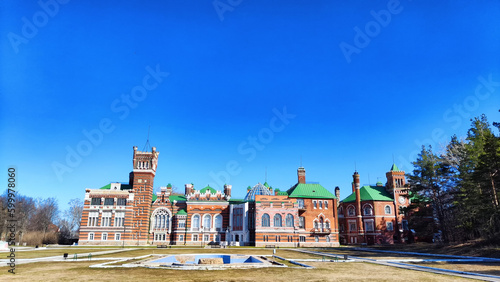 A large red brick castle on a sunny summer day. Sheremetevo Castle in Russia with a mixture of a castle and a Russian manor