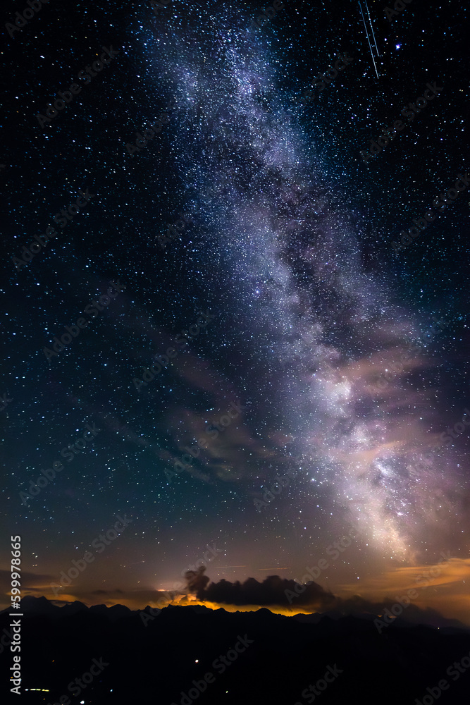 Impressive milky way in the wide sky with two shooting stars taken on the mountain Stockhorn in Switzerland