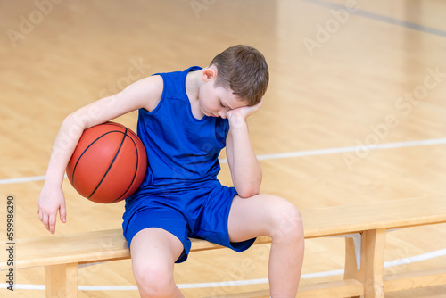 Sad disappointed boy with basketball ball in a physical education lesson © Augustas Cetkauskas