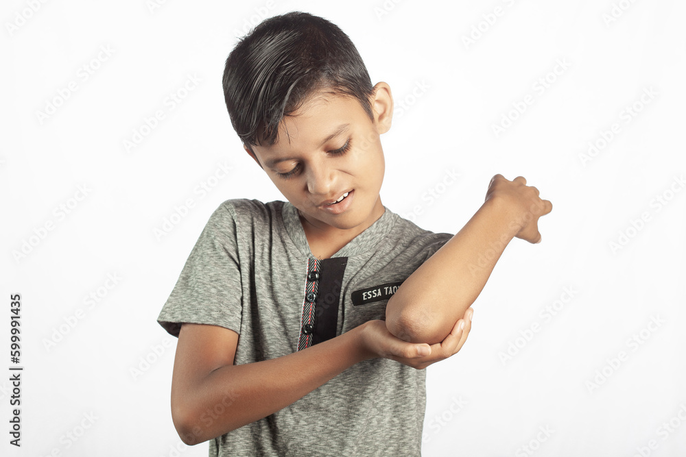 kid suffering from elbow pain in white background kid suffering from elbow pain in white background