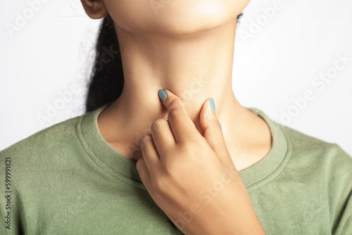 closeup shot of a women suffering from thyroid, tonsil or throat soreness