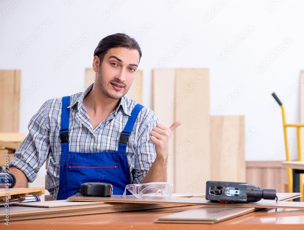 Young male carpenter working indoors Young male carpenter working indoors