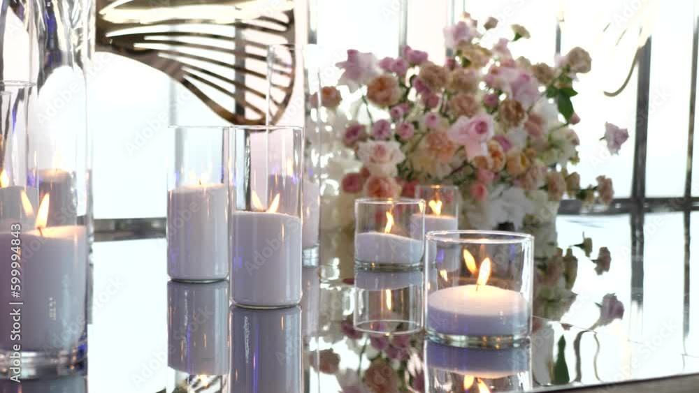 Beautiful glass vases with burning candles.Boho rustic decor. decorations for festive wedding ceremony Beautiful glass vases with burning candles.Boho rustic decor. decorations for festive wedding ceremony