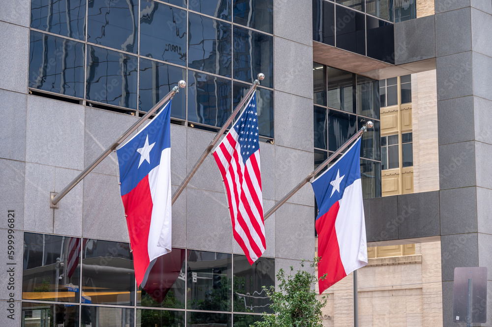 American and Texas flags on office building in downtown Houston.