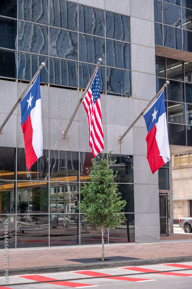 American and Texas flags on office building in downtown Houston. American and Texas flags on office building in downtown Houston.