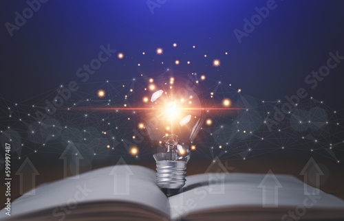 Print op canvas Educational knowledge and business education ideas, Innovations, Glowing light bulb on a book, self-learning, Inspiring from read concept, knowledge and searching for new ideas