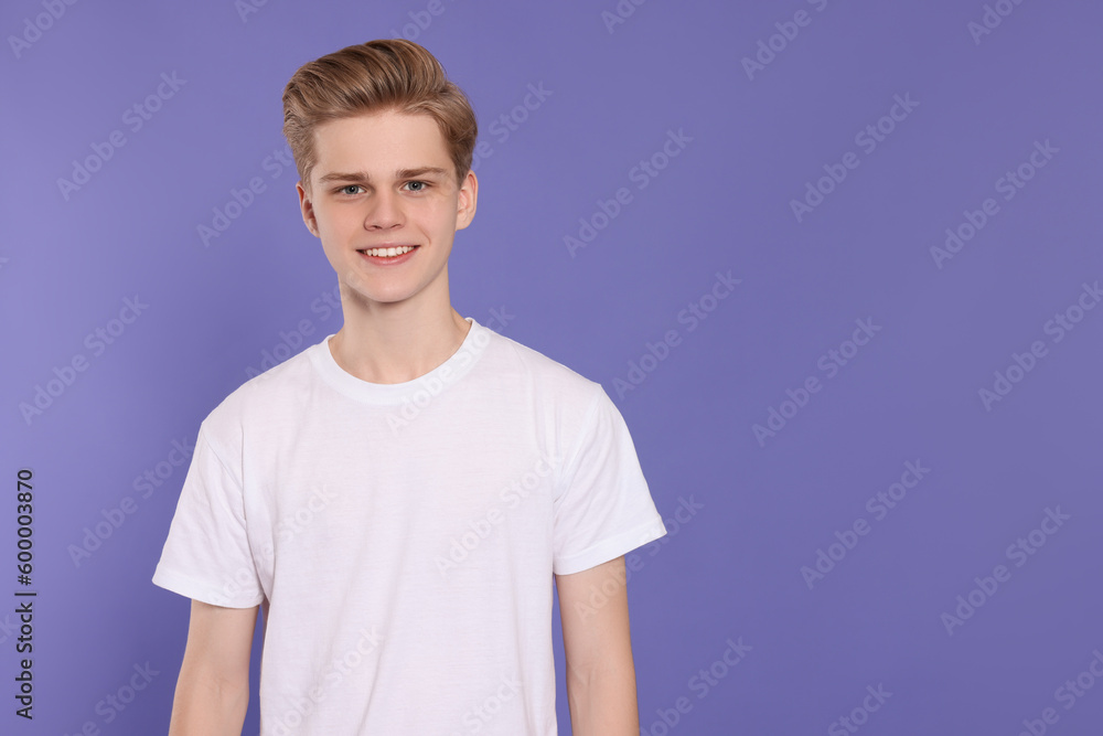 Portrait of teenage boy on purple background. Space for text Portrait of teenage boy on purple background. Space for text