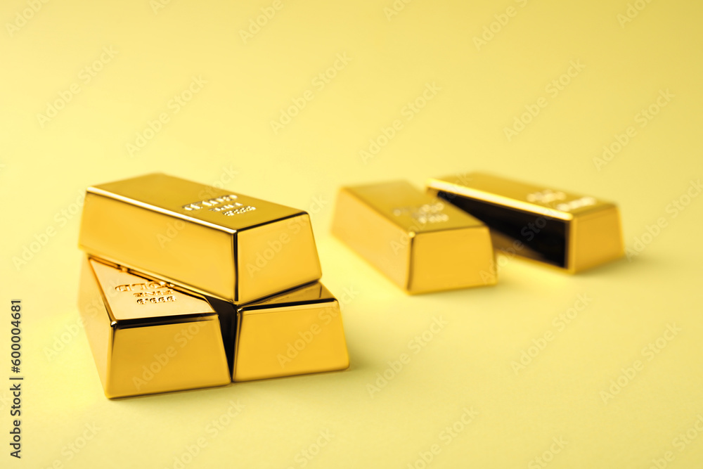 Shiny gold bars on yellow background. Space for text