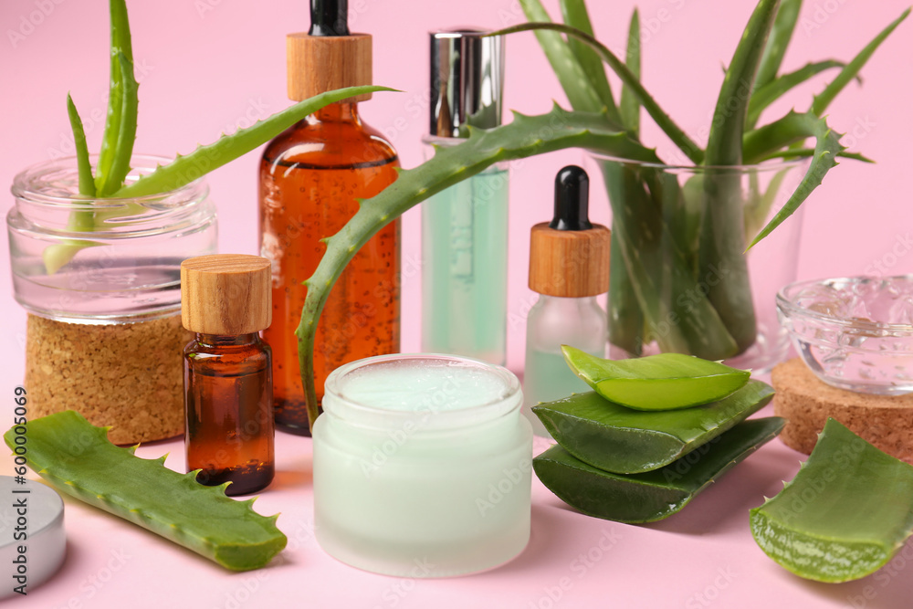 Cosmetic products and cut aloe on pink background Cosmetic products and cut aloe on pink background