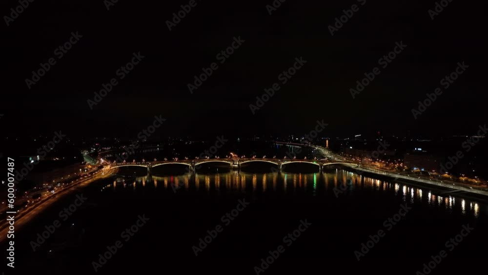 Aerial view of Budapest Margaret Bridge or Margit hid over River Danube, embankment at night. Public transport in the city. Yellow tram passing through the bridge Aerial view of Budapest Margaret Bridge or Margit hid over River Danube, embankment at night. Public transport in the city. Yellow tram passing through the bridge