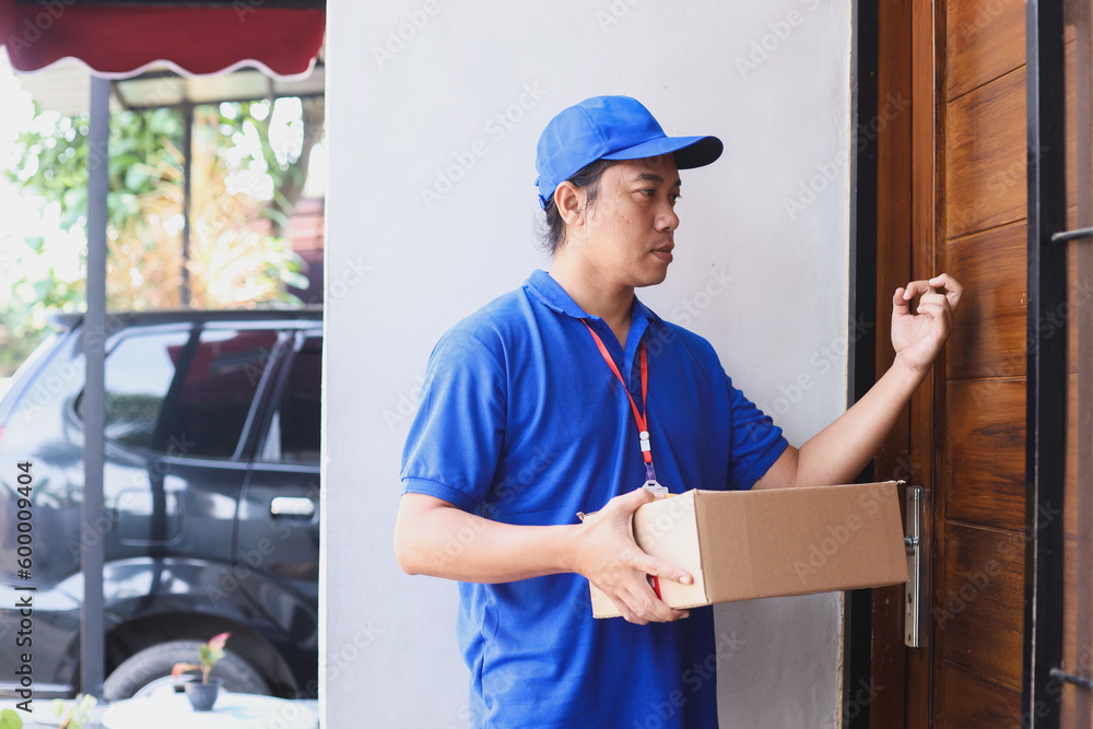 Courier knock the door. Delivery man delivering parcel box to recipient. Courier knock the door. Delivery man delivering parcel box to recipient.