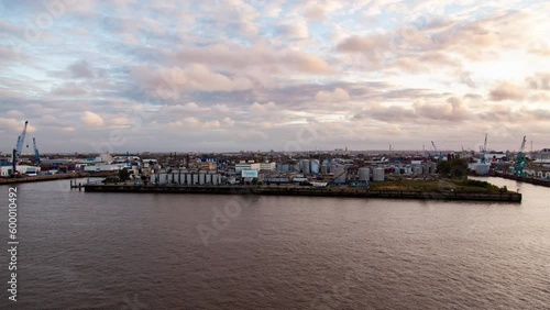 Wallpaper Mural Daytime timelapse of Hamburg's container port with harbor cranes,merchant ships, river scenery, and city skyline under a partly cloudy autumn sky Torontodigital.ca