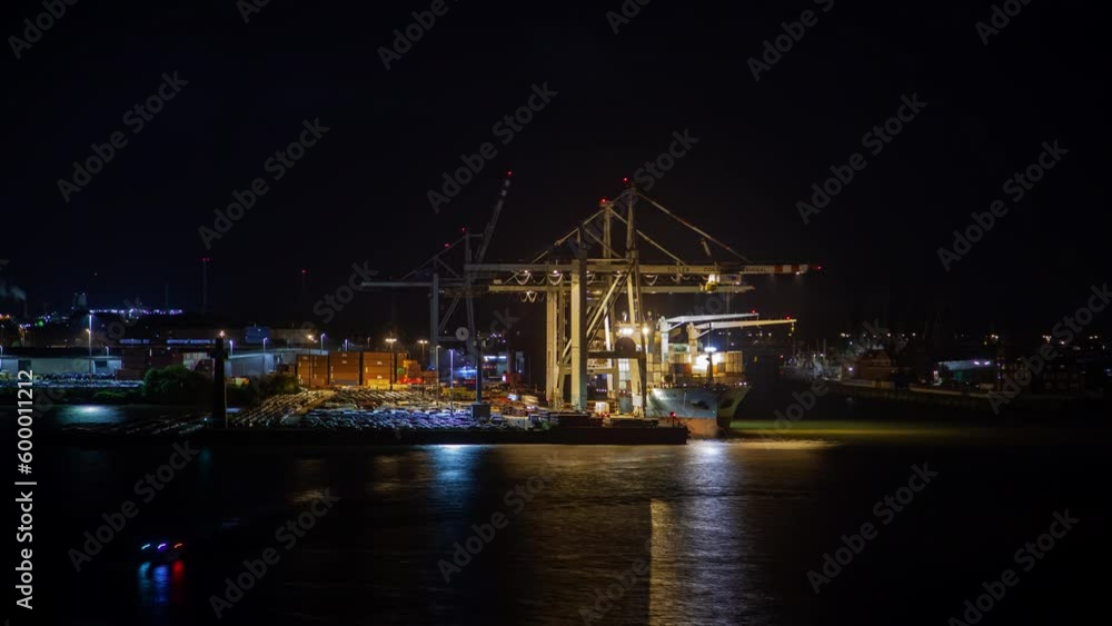 Timelapse of Hamburg's container port and terminal, showcasing harbor cranes, moored merchant ship, and the Elbe River at night in autumn. Timelapse of Hamburg's container port and terminal, showcasing harbor cranes, moored merchant ship, and the Elbe River at night in autumn.