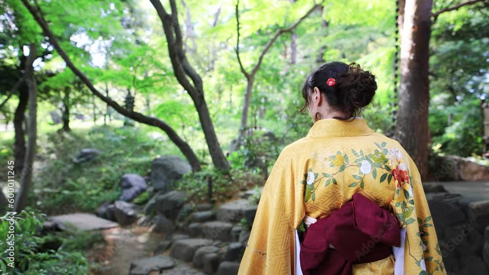 girl in a traditional Japanese silk kimono walking in a bamboo forest, back view of tourist in Japan wearing a kimono in Kyoto girl in a traditional Japanese silk kimono walking in a bamboo forest, back view of tourist in Japan wearing a kimono in Kyoto