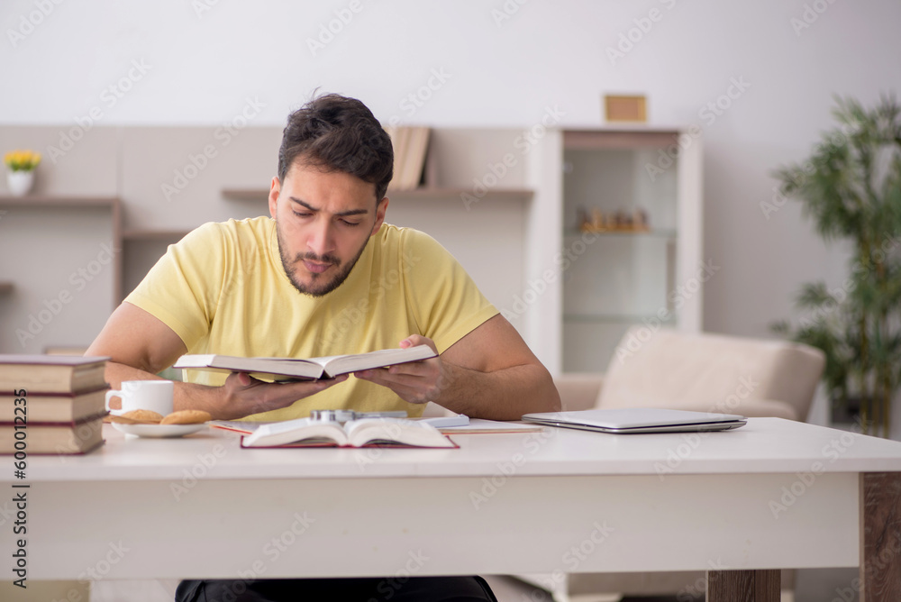 Young male student studying at home Young male student studying at home