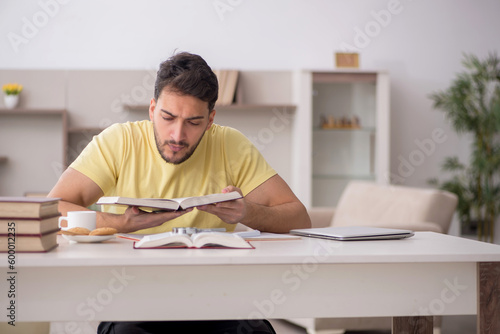 Young male student studying at home