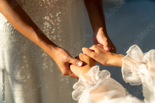 Beautiful Asian woman lesbian couple in white wedding dress holding hands together in wedding ceremony. Diversity sexual equality, lgbtq, pride day, marriage equality and Same-sex marriage concept.