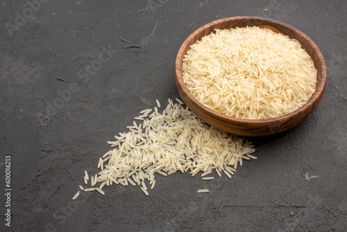 half-top view raw rice inside brown plate on grey background rice raw meal food east cooking photo