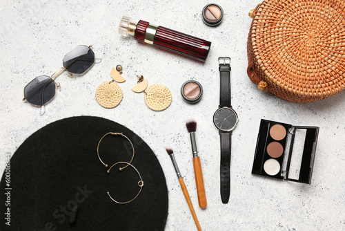 Composition with stylish female accessories and cosmetics on light background