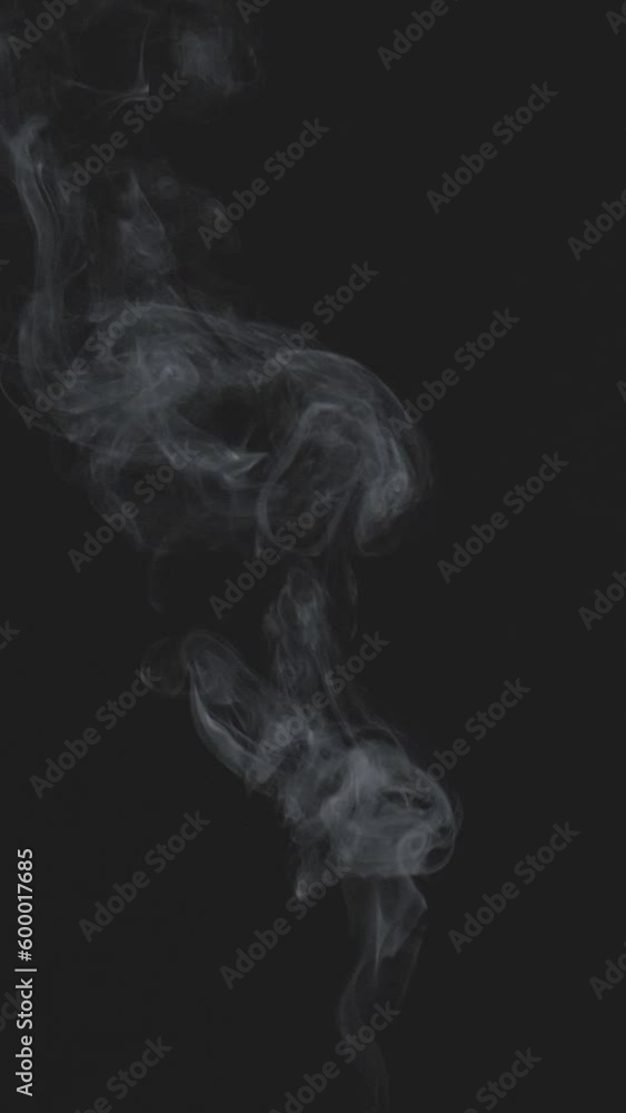 Slow motion vertical video of white smoke, fog, mist, vapor on a black background. Slow motion vertical video of white smoke, fog, mist, vapor on a black background.