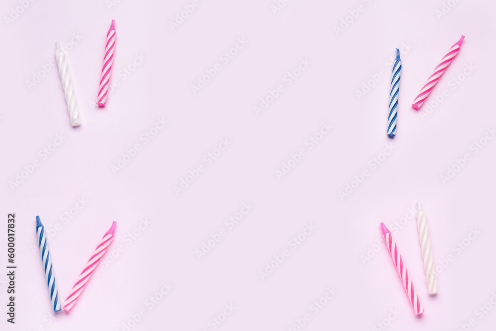 Birthday candles on lilac background