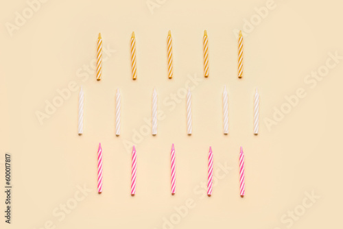 Birthday candles on beige background