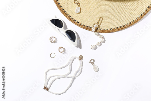 Jewelry with sunglasses and hat on white background