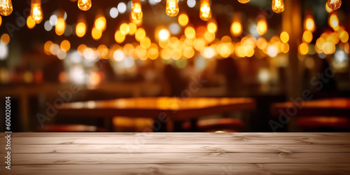 Wooden table in front of abstract blurred restaurant lights background