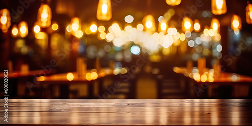 Wooden table in front of abstract blurred restaurant lights background