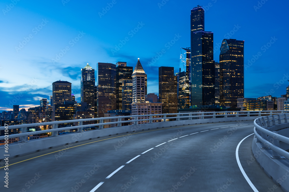 Obraz premium Empty urban asphalt road exterior with city buildings background. New modern highway concrete construction. Concept way to success. Transportation logistic industry fast delivery. Seattle. USA.