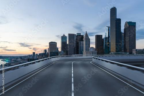 Empty urban asphalt road exterior with city buildings background. New modern highway concrete construction. Concept way to success. Transportation logistic industry fast delivery. Seattle. USA.