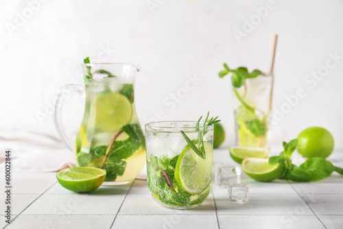 Glass of tasty mojito on table