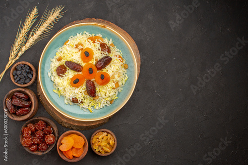 top view delicious cooked plov rice with different raisins inside plate on dark background rice meal food cooking dinner raisin