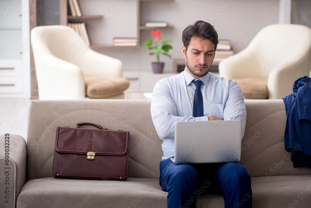 Young male employee working from home during pandemic Young male employee working from home during pandemic
