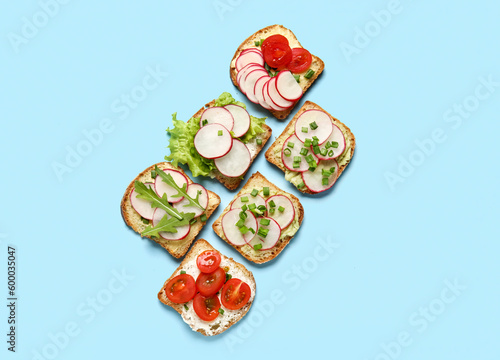 Different radish bruschettas on blue background