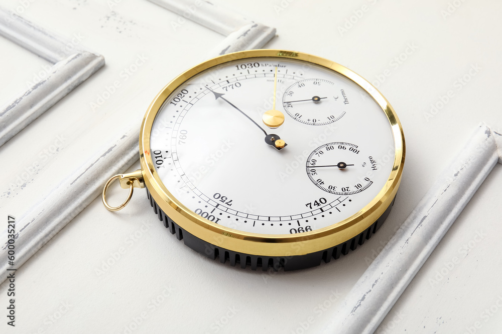 Aneroid barometer on white wooden background Aneroid barometer on white wooden background