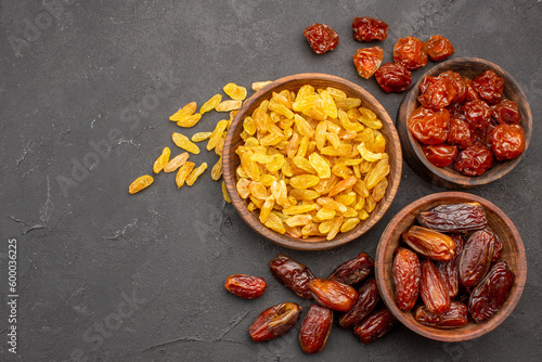 Fototapeta Naklejka Na Ścianę i Meble -  top view different tasty raisins from grape and other fruits on grey background dry fruit raisin food