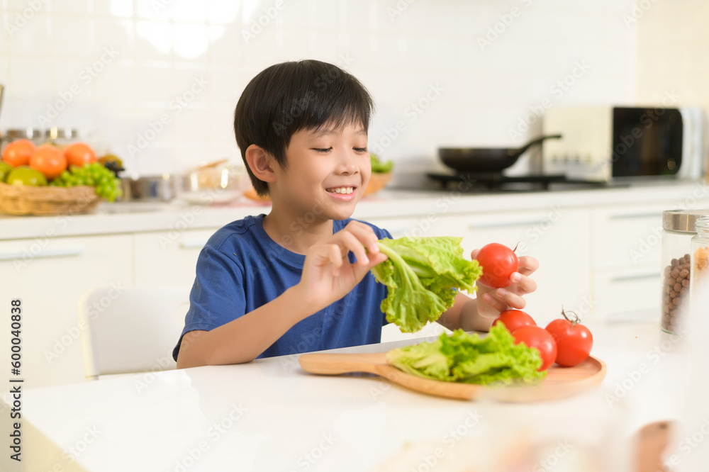 Asian boy feeling happy to eat vegetables , health care concept Asian boy feeling happy to eat vegetables , health care concept