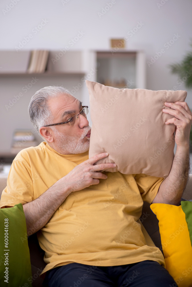 Old man with many pillows at home Old man with many pillows at home