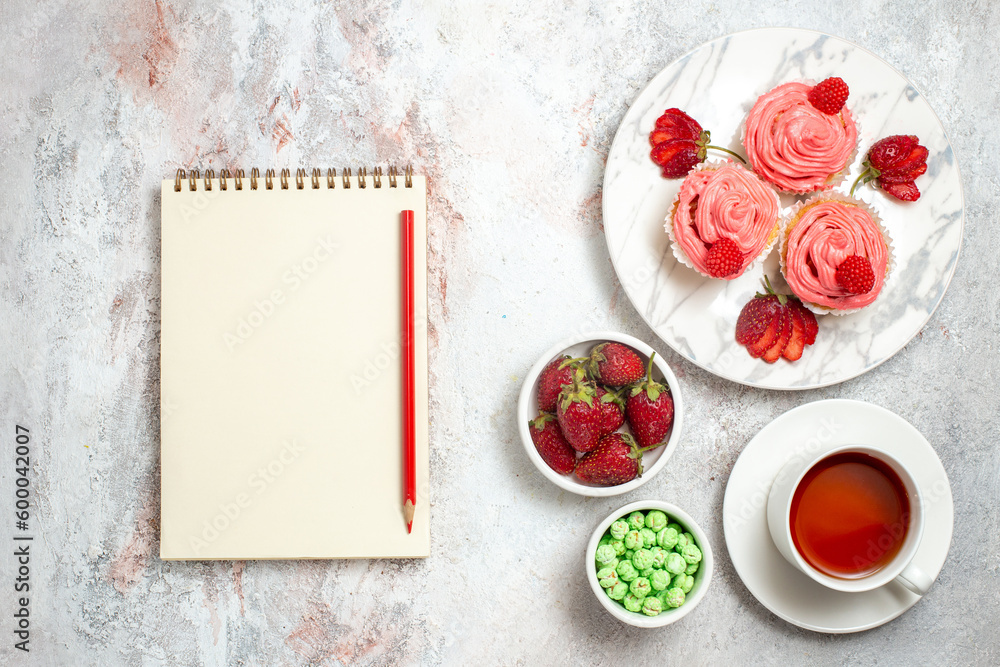 top view pink strawberry cakes with tea on white background biscuit sugar cookie sweet cake tea top view pink strawberry cakes with tea on white background biscuit sugar cookie sweet cake tea