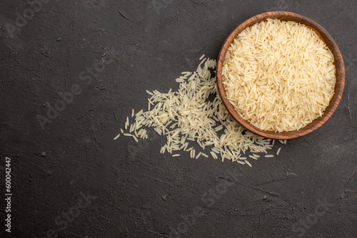 top view raw rice inside brown plate on dark grey background rice raw meal food east cooking photo