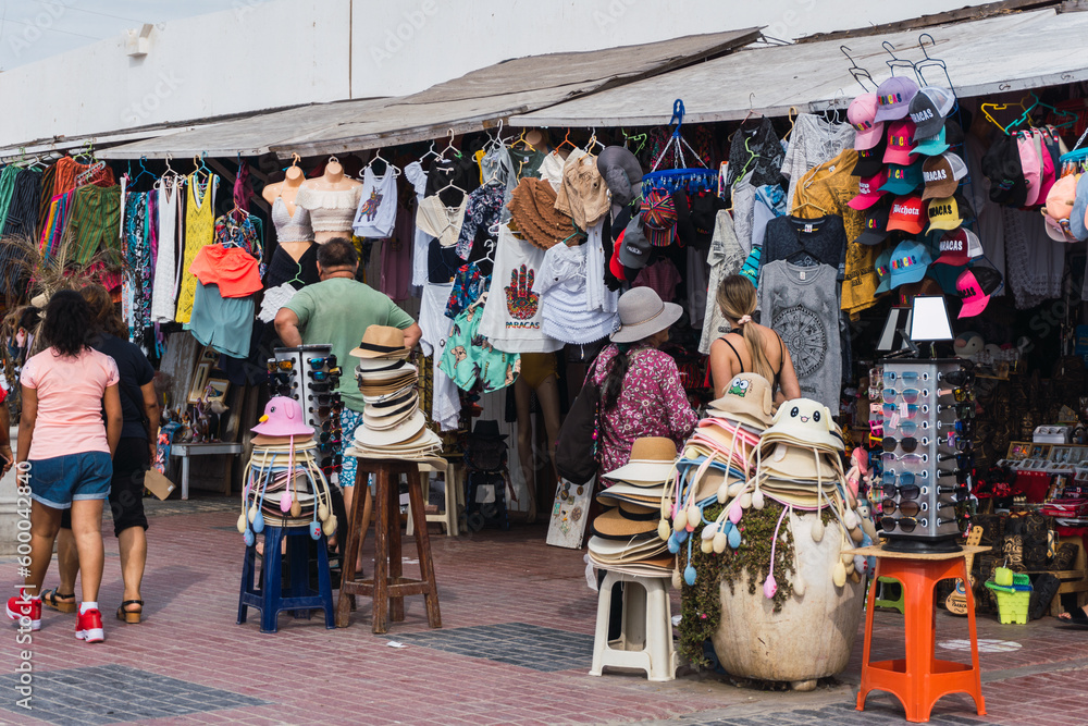 unrecognizable people walking in El Chaco boulevard, Ica Peru, looking for souvenirs