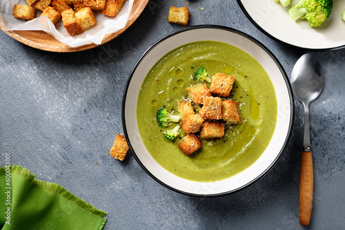 Bowl of fresh broccoli cream soup with croutons , top view