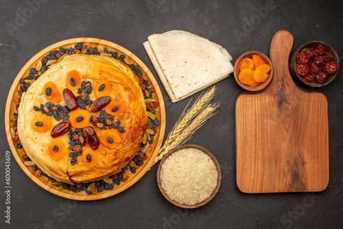 top view shakh plov delicious rice meal cooked inside round dough with raisins on a grey background rice food cooking dough dinner meal photo