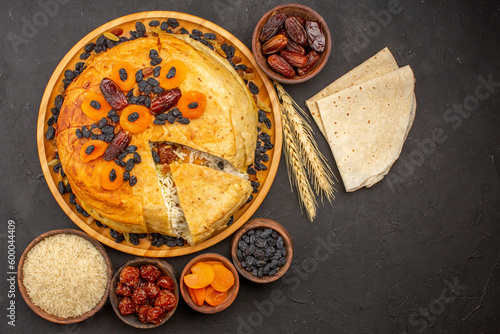 top view shakh plov delicious rice meal cooked inside round dough with raisins on grey floor rice dinner cooking dough photo