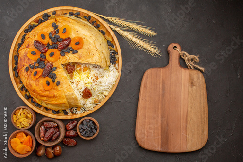 top view tasty shakh plov with raisins and dried apricots on grey background rice dinner meal cooking dough food photo