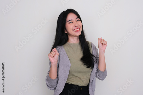 Asian young woman smiling and dancing showing happiness photo