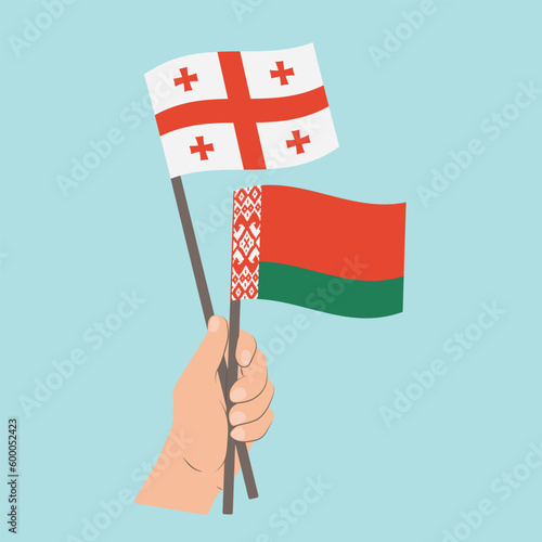 Flags of Georgia and Belarus, Hand Holding flags © Настасья Стось